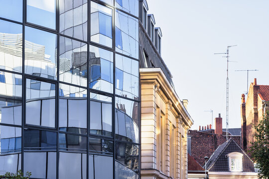 modern glass facade beside old building in Lille, France