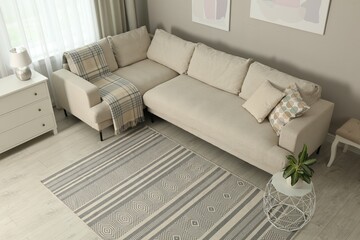 Living room interior with stylish rug and furniture, above view