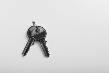 Keys on white background, top view and space for text. Real estate agent services