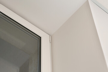 Glass plastic window near white wall indoors, low angle view