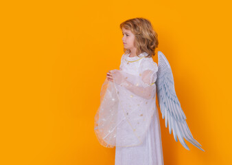 Angel prayer. Little cupid angel child with wings with prayer hands, hope and pray concept. Studio...