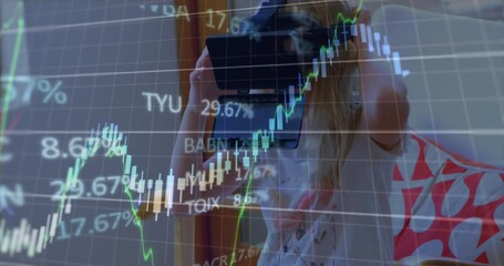 Animation of financial data processing over caucasian woman using vr headset - Powered by Adobe