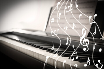 Music notes and other musical symbols over piano, closeup. Black and white effect