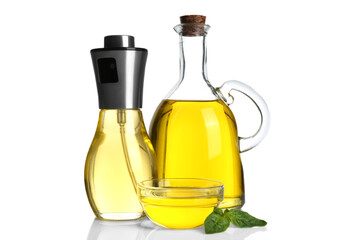 Cooking oil and basil leaves on white background
