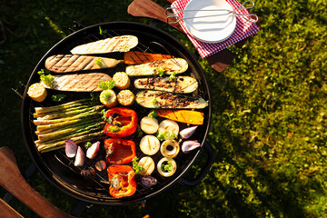Delicious grilled vegetables on barbecue grill outdoors, top view. Space for text
