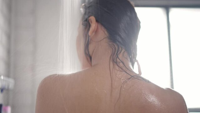 Asian woman washing hair and showering	
