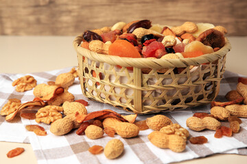 Fototapeta na wymiar Mixed dried fruits and nuts on beige background