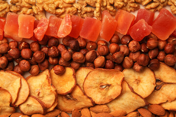Mix of delicious dried nuts and fruits as background, top view
