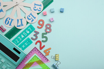 Flat lay composition with colorful numbers and rulers on light background. Space for text