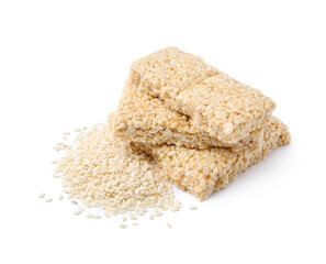 Delicious sweet kozinaki bars and sesame seeds on white background