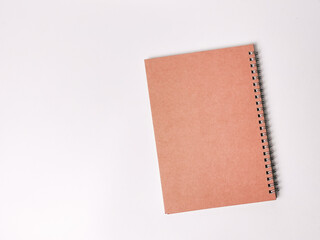 Top view closed brown notebook isolated on white background with copy space.