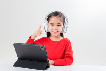 little girl asia cute put on headphones have video call distant class with teacher using laptop, ...