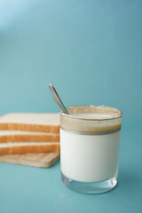 glass of milk and breads on table 