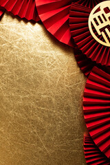 Chinese Lunar New Year golden background with red paper fans