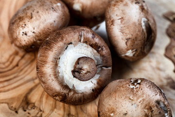 Champignon mushrooms in close up view on wood