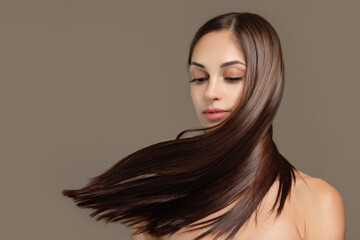 Fashionable brunette woman with straight long shiny hair. beauty and hair care