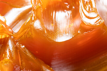 Close up of orange colored industrial grease. Rich and thick texture of industrial grade grease...