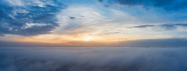 Naklejka na ściany i meble A wonderful dawn above the clouds. Natural background