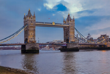 View of the London city skyline at sunset with Tower Bridge on Thames river in England, United Kingdom