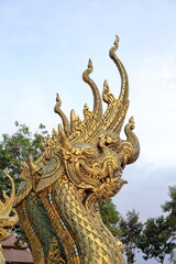 Fototapeta na wymiar Golden Naga statue in Thai temple