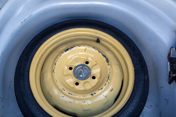 Stepney or donut tyre in a car boot space for temporary use