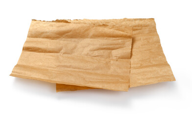 Baking paper isolated. Crumpled pieces of brown parchment or baking paper on white background....