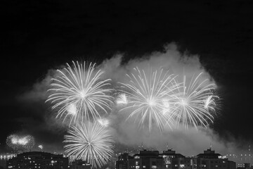 NITERÓI, RIO DE JANEIRO, BRAZIL – 01/01/2023: Night photo of the arrival of the New Year (Réveillon) in black and white with fireworks in the sky of a Brazilian city