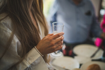 Lady with long brown hair holding a glass of champagne