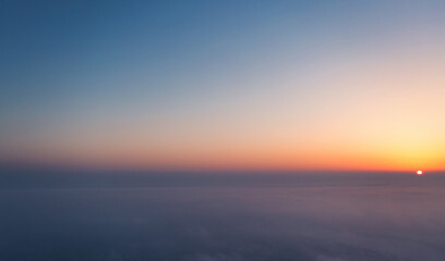 Fototapeta premium A wonderful dawn above the clouds. Natural background