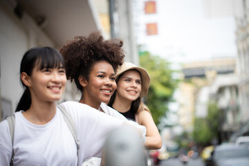 Diversity people, leisure and teenage concept - group of happy friends in sunglasses hugging and laughing on city street
