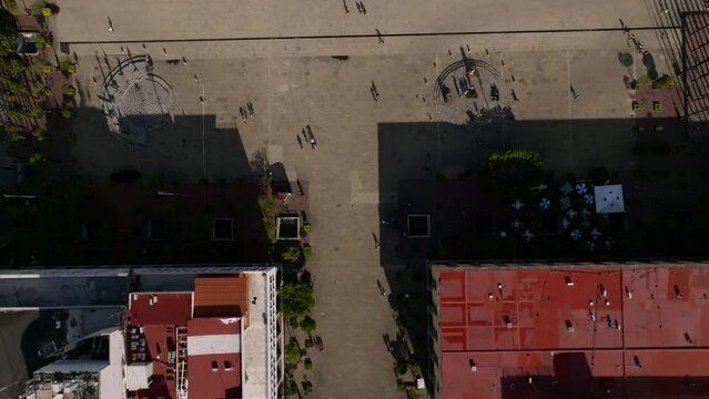 Overhead View Of People Walking In Front Of Hospicio Cabañas On A Sunny Day In Guadalajara, Jalisco, Mexico. - aerial