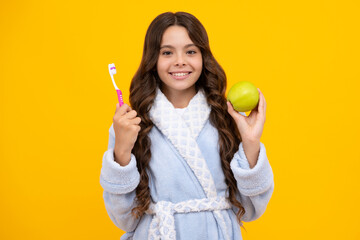 Teen girl hold toothbrush, childhood happiness, morning routine. Apple vitamins for healthy teeth. Brush teeth, dental health and oral care. Child brush her teeth.