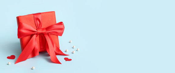 Beautiful gift box for Valentine's Day celebration on light blue background with space for text