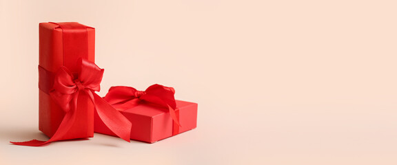 Red gifts for Valentine's Day celebration on beige background with space for text
