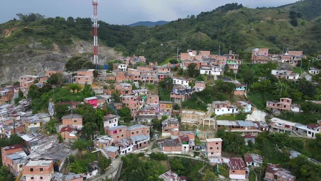 Aerial shot drone flying over top of shanty town comuna 13 with lightning in background