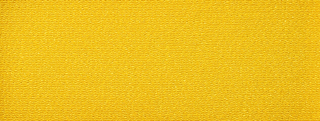 ちりめん状の質感のある黄色い布地の背景テクスチャー