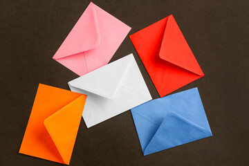 Many different paper envelopes on dark background