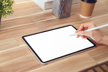 Hand holding digital pen and using tablet mockup of blank screen. Take your screen to put on advertising.