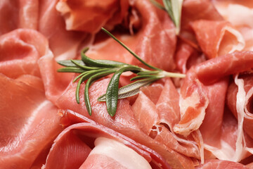 Slices of delicious ham and rosemary, closeup