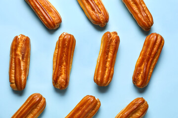 Many sweet eclairs on color background