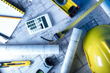 Contractor theme. Plans,  notebook, calculator and tool kit of the contractor: yellow hardhat and...