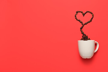 Cup and heart made of coffee beans on red background. Valentine's Day celebration
