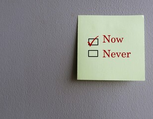 Blue note stick on notebook with text NOW or NEVER, concept of doing it now, take action to reach...