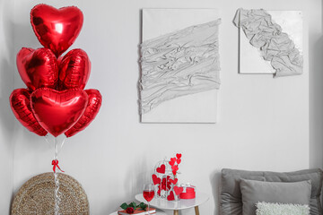 Interior of living room decorated for Valentine's Day with balloons and paintings