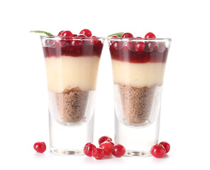 Shots of delicious pudding with cranberry, mint and jam isolated on white background