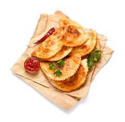 Parchment with tasty chebureks, parsley, chilli pepper and sauce on white background