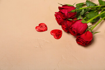 Red roses and hearts on beige background. Valentine's Day celebration