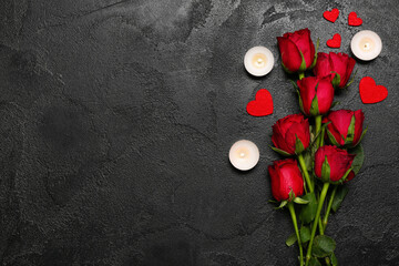 Red roses, candles and hearts on dark background. Valentine's Day celebration