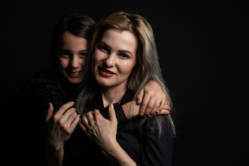 a little girl with her mother is praying while hugging