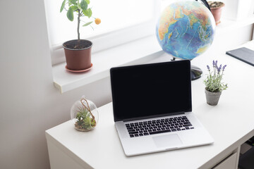 portable office desk with mock-up computer devices, supplies and decorations on white table